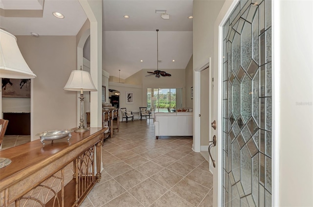 entrance foyer featuring lofted ceiling, light tile patterned floors, and ceiling fan