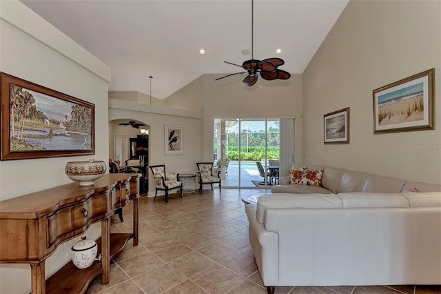 living room featuring light tile patterned flooring, ceiling fan, and high vaulted ceiling