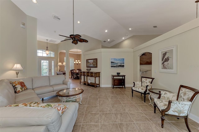 living room featuring high vaulted ceiling, ceiling fan, and light tile patterned flooring