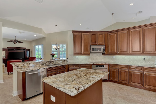 kitchen featuring appliances with stainless steel finishes, tasteful backsplash, lofted ceiling, sink, and a center island