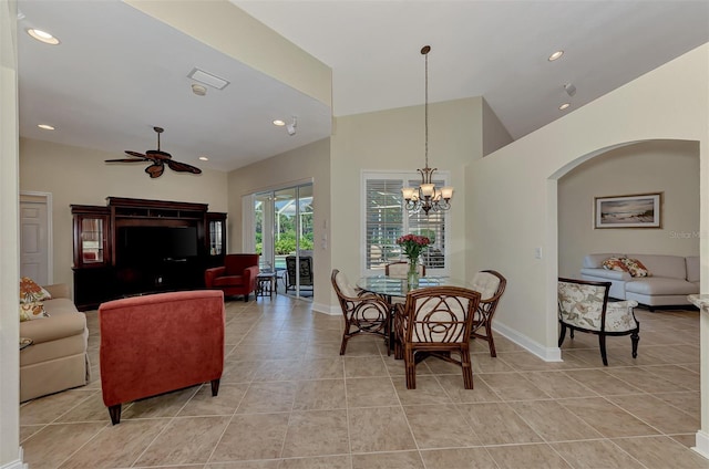 tiled dining area featuring ceiling fan with notable chandelier