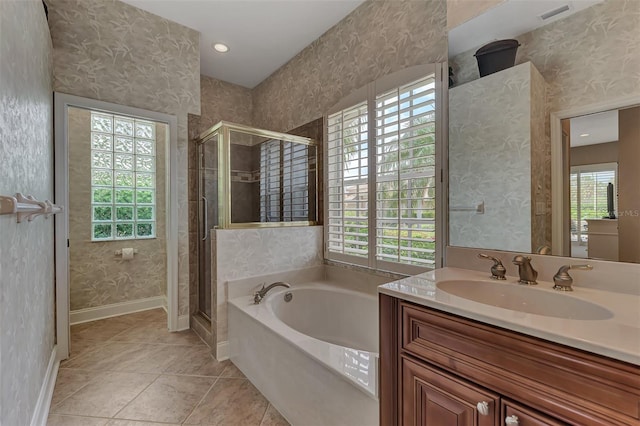 bathroom with tile patterned floors, vanity, and independent shower and bath