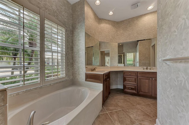 bathroom with vanity, a bathing tub, and tile patterned floors