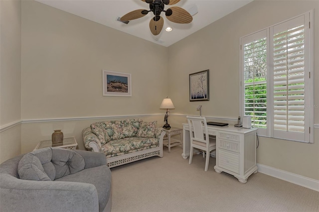 carpeted office space with ceiling fan and a healthy amount of sunlight