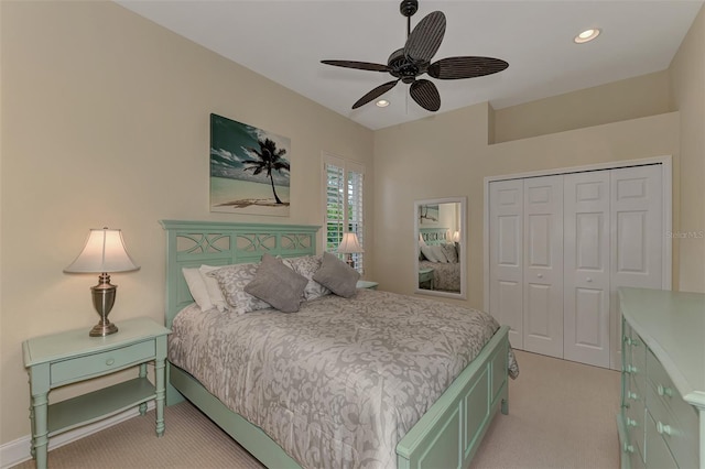 bedroom with light carpet, a closet, and ceiling fan