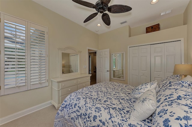 carpeted bedroom featuring ceiling fan and a closet