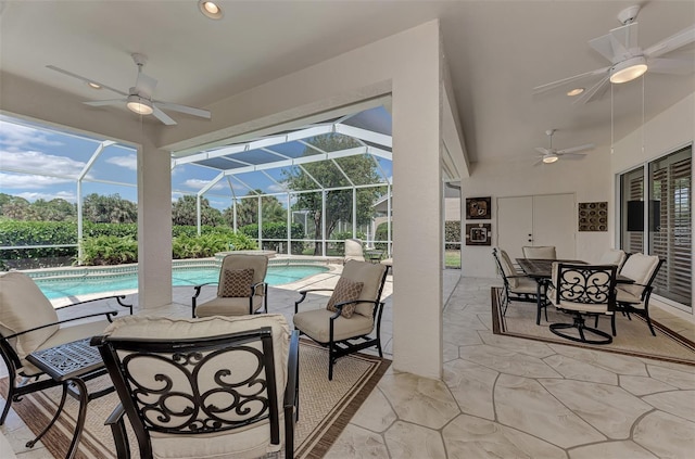 view of patio with ceiling fan and a lanai