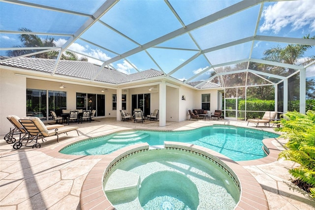 view of swimming pool with an in ground hot tub, ceiling fan, a lanai, and a patio area