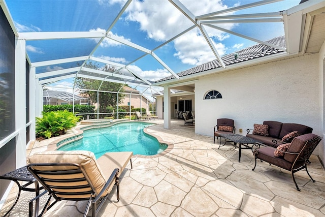 view of swimming pool featuring an in ground hot tub, outdoor lounge area, glass enclosure, and a patio area