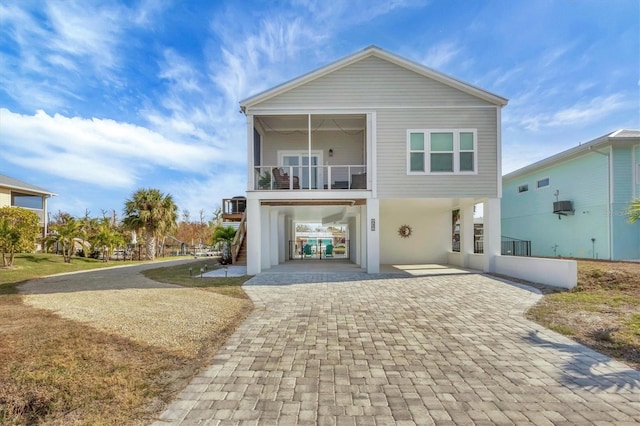 view of front of home featuring a carport and a balcony