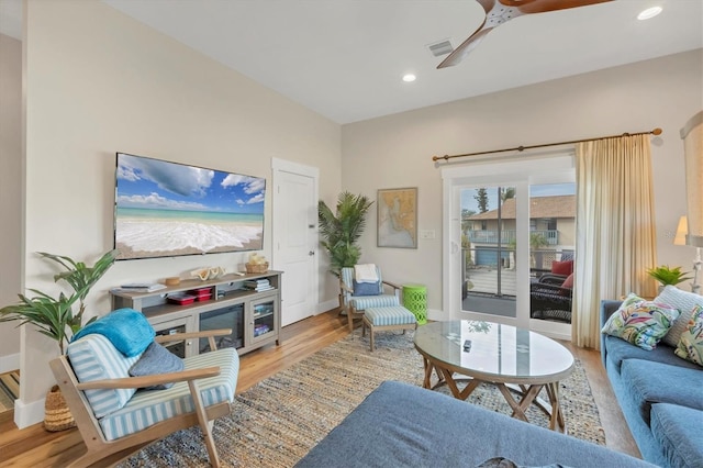 living room with ceiling fan and light hardwood / wood-style floors