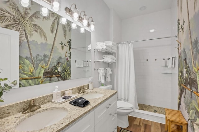 bathroom with a shower with curtain, vanity, hardwood / wood-style flooring, and toilet