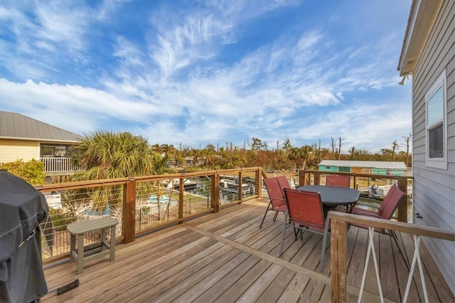 wooden deck with a grill