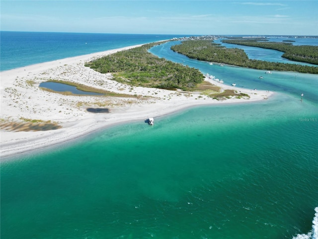 drone / aerial view with a beach view and a water view