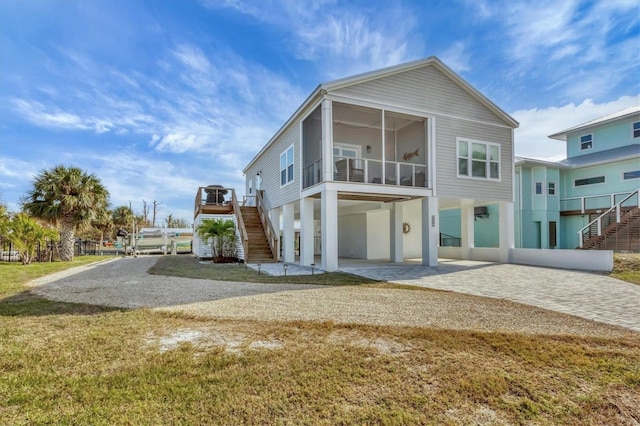 rear view of house with a carport and a sunroom