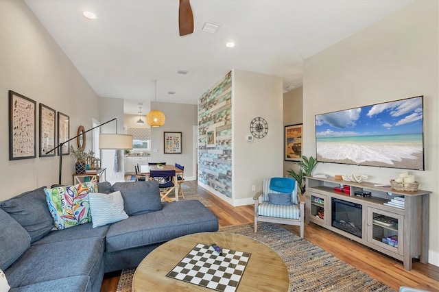 living room featuring ceiling fan and light hardwood / wood-style flooring