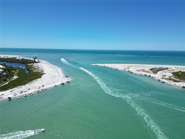 birds eye view of property with a water view and a beach view