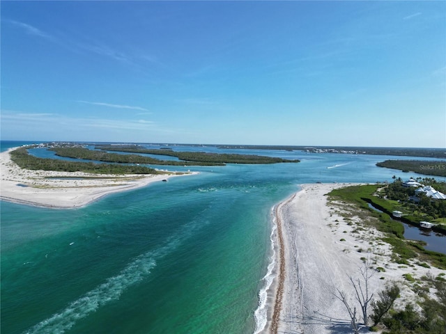 birds eye view of property with a water view and a view of the beach