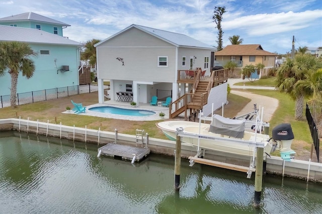 10451 Sherman St, Englewood, FL 34224 - rear view of property featuring stairs, boat lift, a patio, a fenced backyard, and a deck with water view