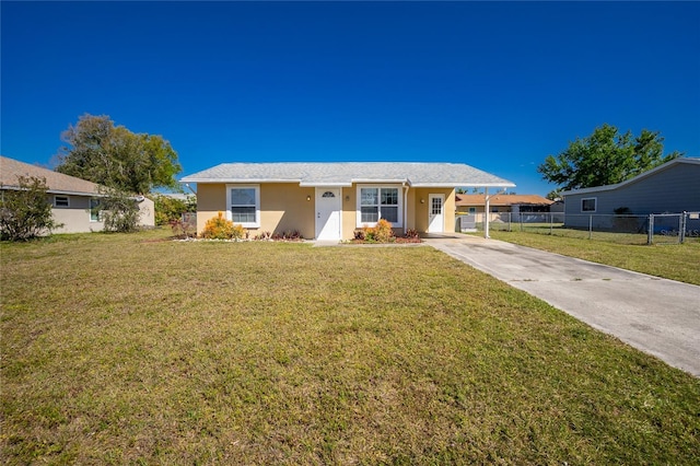 ranch-style house with a carport, a front lawn, fence, and stucco siding