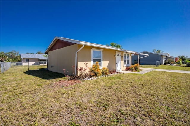 single story home with a front yard, fence, and stucco siding