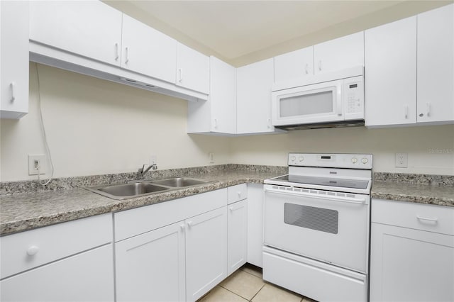 kitchen featuring light tile patterned floors, white appliances, a sink, white cabinetry, and light countertops