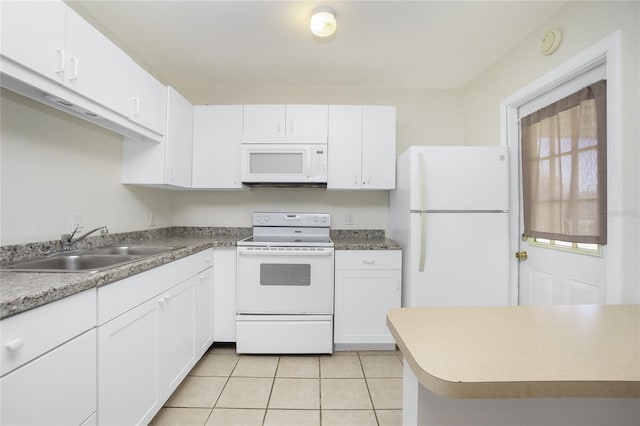 kitchen featuring light tile patterned floors, white appliances, a sink, and white cabinetry