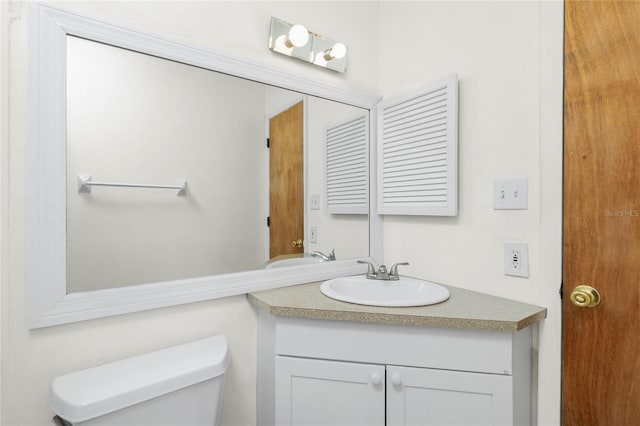 half bath with vanity and toilet