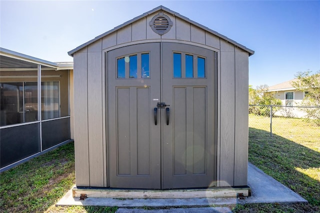 view of shed featuring fence