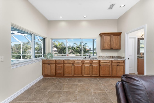 kitchen with light stone countertops and sink