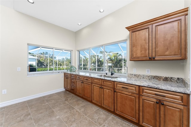 kitchen with sink and light stone counters