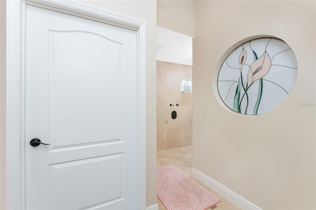 bathroom with tiled shower