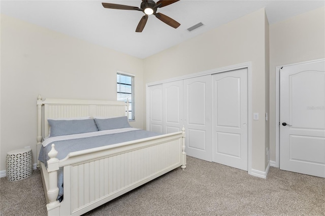 carpeted bedroom featuring a closet and ceiling fan