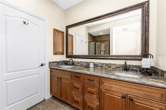 bathroom featuring walk in shower, vanity, and tile patterned flooring