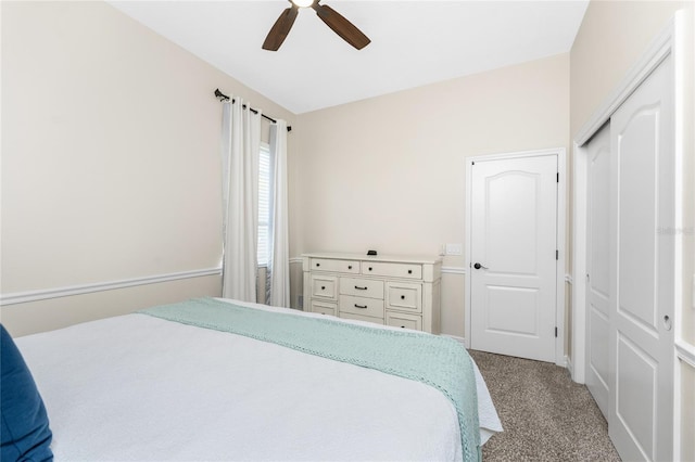 carpeted bedroom with ceiling fan and a closet