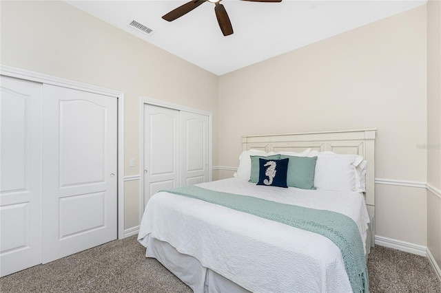 bedroom featuring multiple closets, ceiling fan, and carpet