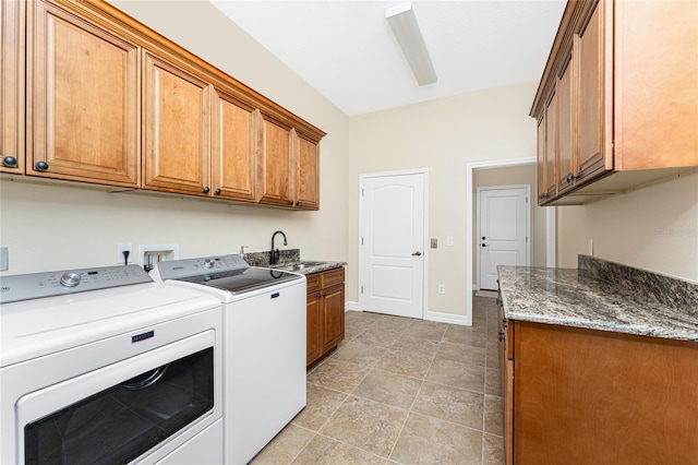 laundry area with cabinets, washer and clothes dryer, and sink