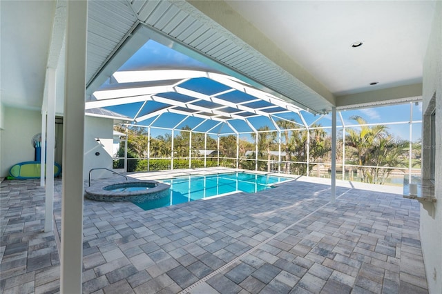 view of pool with an in ground hot tub, a lanai, and a patio area