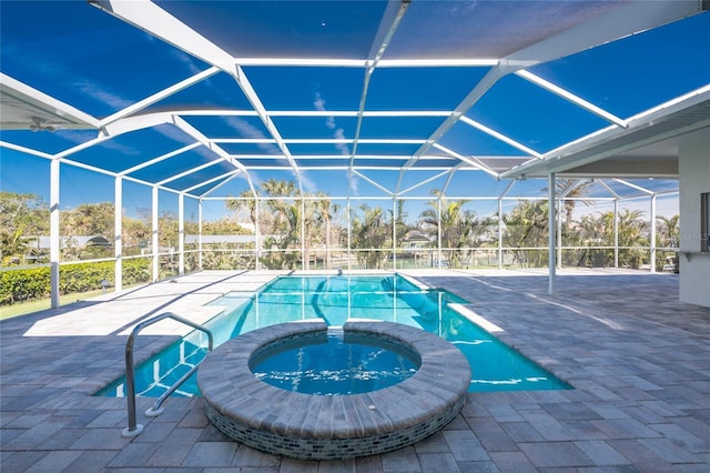 view of pool featuring an in ground hot tub, a patio, and glass enclosure