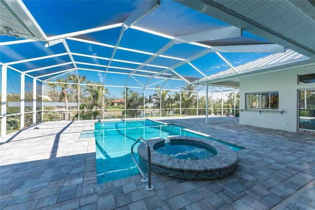 view of pool featuring an in ground hot tub, a lanai, and a patio area