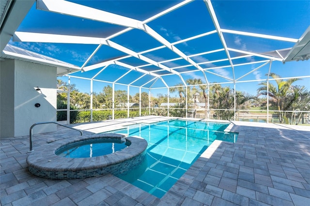 view of swimming pool featuring an in ground hot tub, a lanai, and a patio area