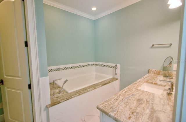 bathroom featuring crown molding, a relaxing tiled tub, and vanity