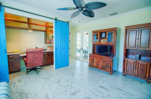 office featuring french doors, ceiling fan, ornamental molding, and a barn door