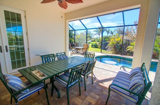 view of patio / terrace with ceiling fan and a lanai