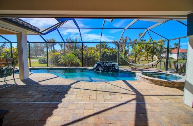 view of swimming pool featuring an in ground hot tub, glass enclosure, and a patio