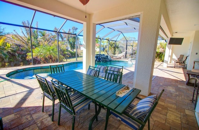 view of patio / terrace with ceiling fan and glass enclosure