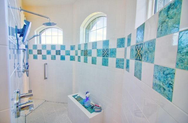 bathroom with tile patterned flooring and tiled shower