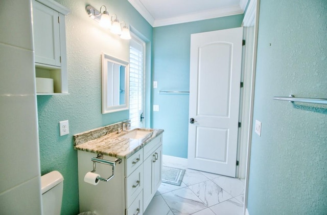 bathroom with vanity, crown molding, and toilet