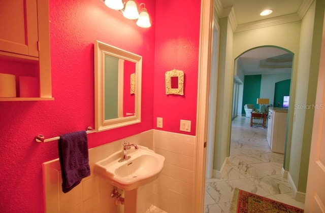 bathroom with ornamental molding and sink