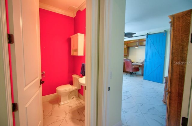 bathroom featuring crown molding and toilet